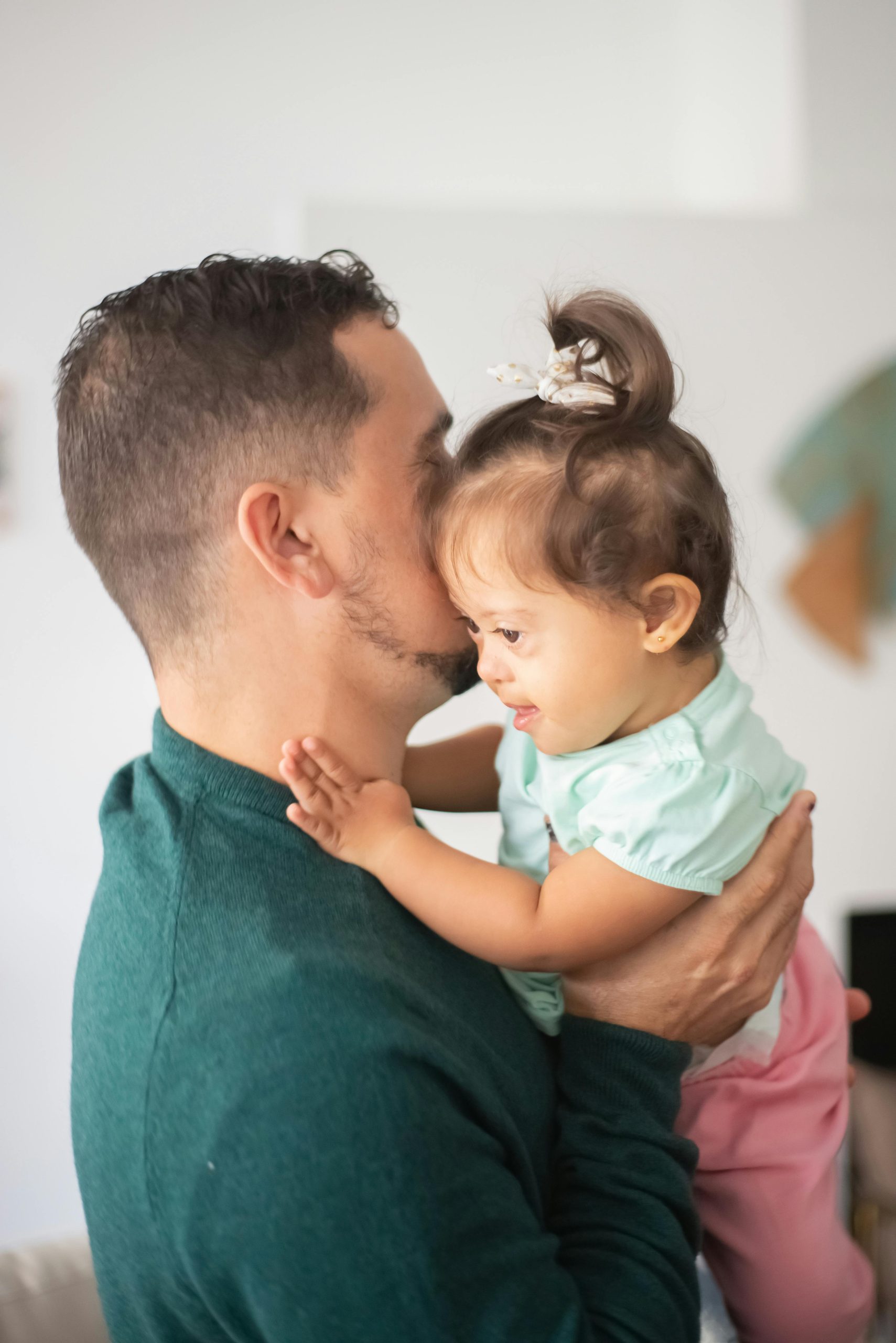 Parent and autistic child practicing sensory regulation techniques together.